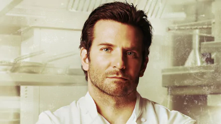 HD desktop wallpaper: close-up of a stubbled male chef in a white coat in a restaurant kitchen, cinematic portrait evoking the movie Burnt.