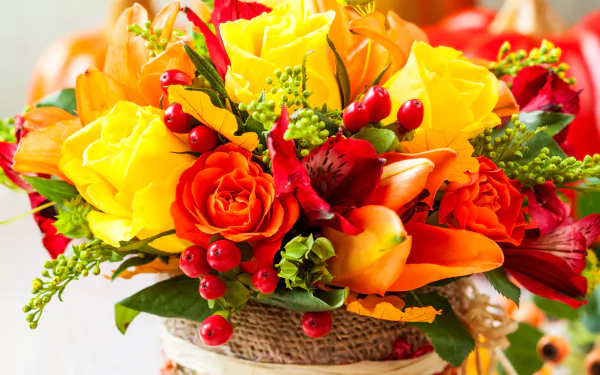A vibrant bouquet featuring yellow and red flowers, including roses and berries, showcased in a decorative vase. This colorful display serves as an appealing HD desktop wallpaper.