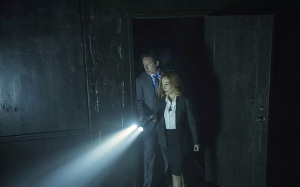 Two investigators in business attire sweep a dark room with flashlight beams; moody 4K Ultra HD TV-series desktop wallpaper evoking a 1990s paranormal drama.