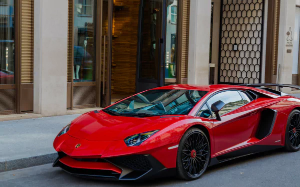 A striking red Lamborghini Aventador SV parked on a city street, captured in high detail for a 4K Ultra HD PC desktop wallpaper and background.