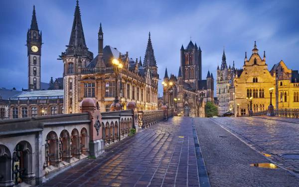 A stunning night view of Ghent, Belgium, showcasing its intricate architecture, illuminated buildings, and cobblestone streets, creating a captivating man-made landscape.