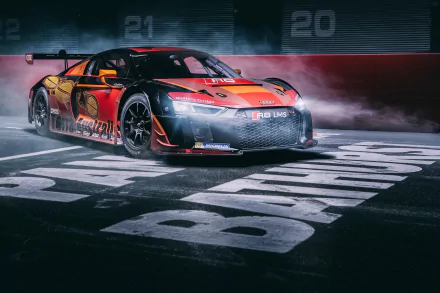 HD desktop wallpaper featuring a dynamic Audi R8 LMS race car with bold red and black livery on a smoky racetrack background.