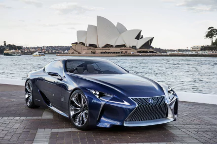 A sleek blue Lexus LC 500 parked by the waterfront with the iconic Sydney Opera House in Australia in the background, captured in HD for a desktop wallpaper.