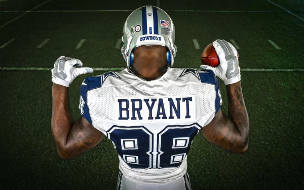 HD PC desktop wallpaper featuring Dallas Cowboys player Bryant wearing jersey number 88, holding a football poised on a dimly lit field.