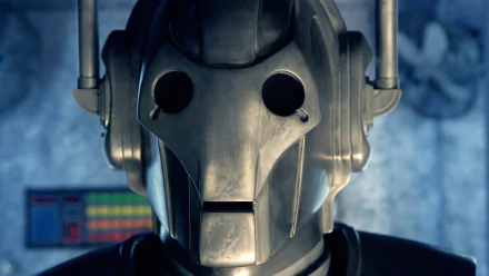 Close-up of a Cyberman (Doctor Who) from the TV show Doctor Who (2005) on an HD PC desktop wallpaper, metallic helmet with dark eye sockets set against a blue, smoky backdrop.