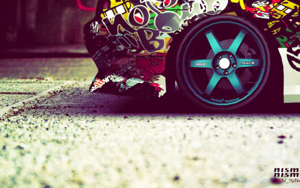 A close-up of a modified JDM vehicle featuring vibrant stickers and bold wheels, set against a textured surface. This HD image serves as an eye-catching desktop wallpaper.