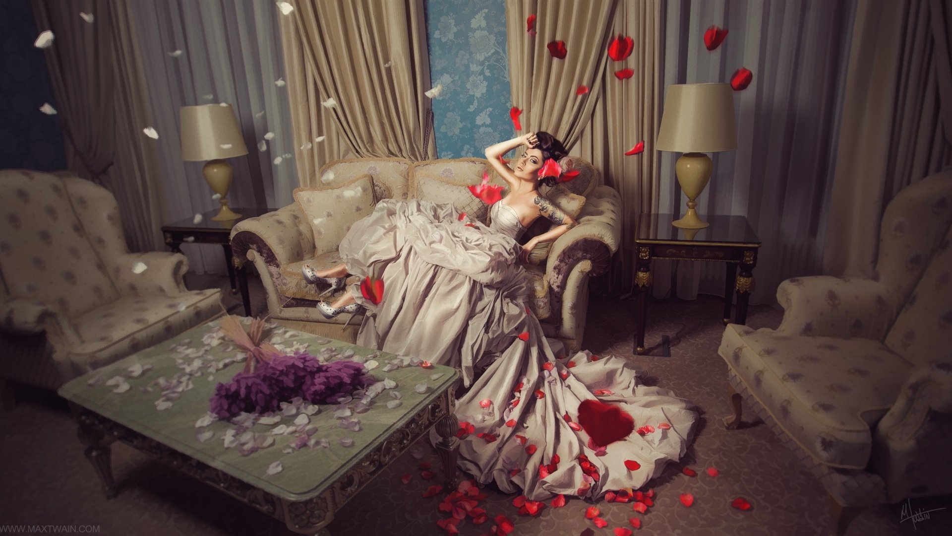 Artistic 2K Quad HD desktop wallpaper: brunette in a flowing dress with floral tattoo reclines on a living-room couch amid scattered red petals, painting-like composition.