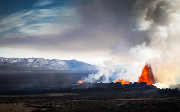 Bárðarbunga volcano eruption in Iceland with glowing lava and smoke rising over a dark volcanic landscape under a cloudy sky.