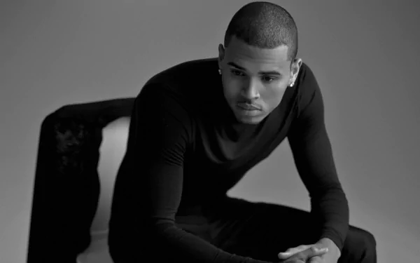 Black and white HD desktop wallpaper featuring Chris Brown in a contemplative pose, highlighting his music persona.