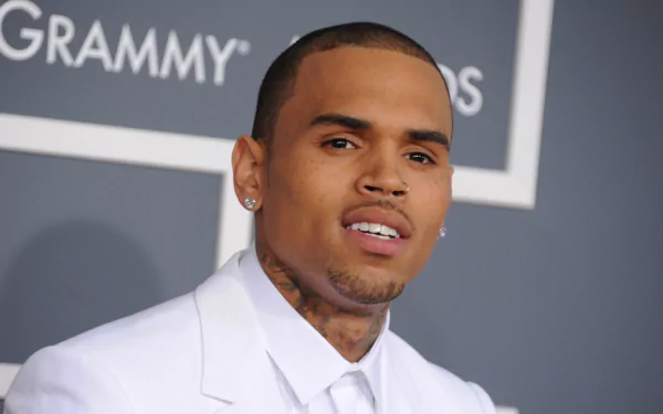 Chris Brown is featured in this HD PC Desktop Wallpaper and Background, presenting a dynamic image of the artist at a Grammy event, showcasing his style and charisma.