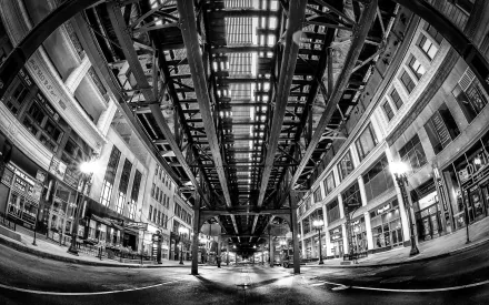 Black and white fisheye lens view of a city street under an elevated train structure, as an HD desktop wallpaper background.