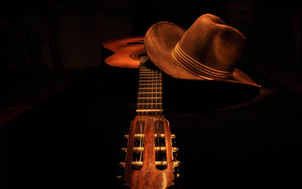 A still life composition featuring a guitar and a cowboy hat, captured in rich detail against a dark background. This HD image enhances desktop backgrounds with a musical theme.