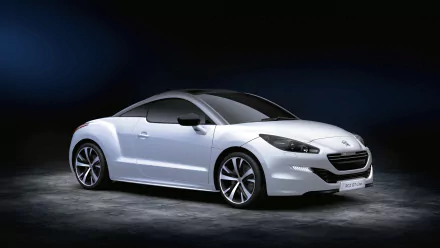 A sleek white Peugeot RCZ sports car showcased against a dark background in 4K Ultra HD quality, highlighting its modern design and sharp curves.