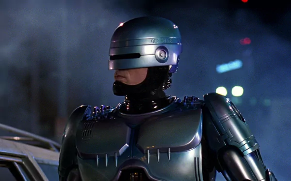 HD PC desktop wallpaper of Robocop from the 1987 movie, featuring the iconic armored cyborg police officer in a dark, smoky urban setting.