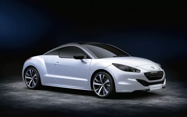 A sleek white Peugeot RCZ sports car showcased against a dark background in 4K Ultra HD quality, highlighting its modern design and sharp curves.