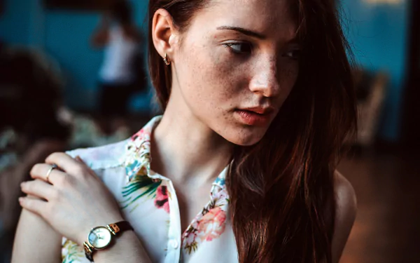 Moody close-up portrait of a freckled redhead woman model, soft light and contemplative expression — 4K Ultra HD PC desktop wallpaper/background.