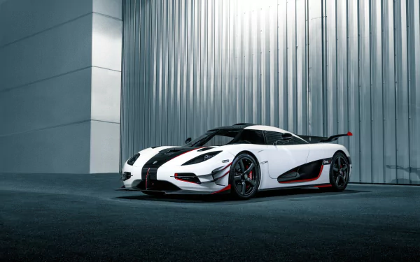 A striking Koenigsegg Agera supercar parked against a sleek metallic backdrop, showcasing its aerodynamic design and bold colors. An impressive HD desktop wallpaper for car enthusiasts.