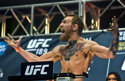 Conor McGregor celebrating energetically at a UFC weigh-in event, captured in stunning 4K Ultra HD for a dynamic sports desktop wallpaper.