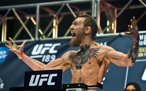 Conor McGregor celebrating energetically at a UFC weigh-in event, captured in stunning 4K Ultra HD for a dynamic sports desktop wallpaper.