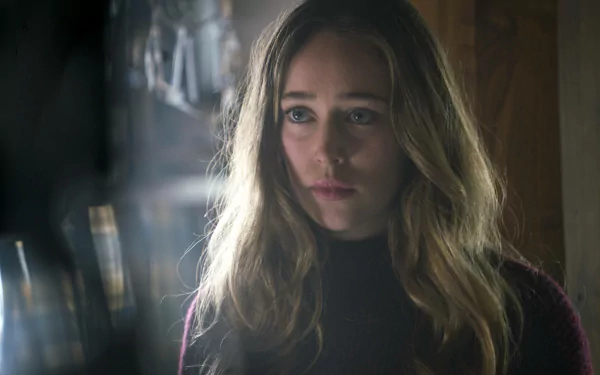 Alycia Debnam-Carey appears in a contemplative moment, captured in this HD wallpaper from the TV show Fear the Walking Dead, featuring a moody, atmospheric setting.