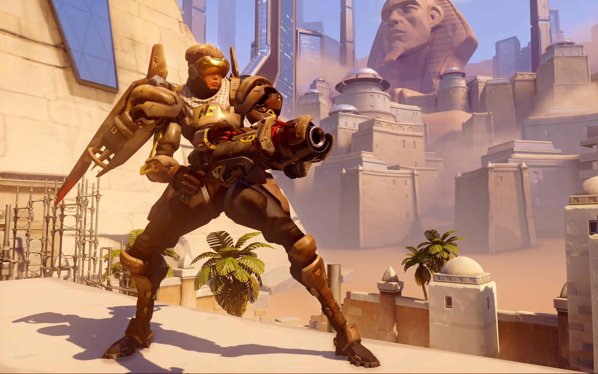 Pharah (Overwatch) in powered armor aiming her rocket launcher on a sunlit Egyptian map with a sphinx and palm trees — video game art, 4K Ultra HD PC desktop wallpaper/background.