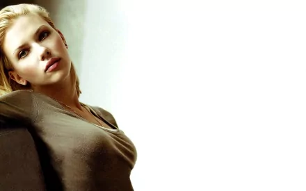 HD desktop wallpaper featuring Scarlett Johansson in a relaxed pose against a minimalist background.