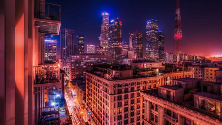 A stunning 4K Ultra HD wallpaper showcasing the vibrant skyline of Los Angeles at night, featuring illuminated skyscrapers and a bustling urban atmosphere.