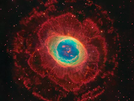 A vibrant supernova explodes in a cosmic display, showcasing swirling colors of red, blue, and green against a star-filled backdrop in this stunning HD space-themed wallpaper.