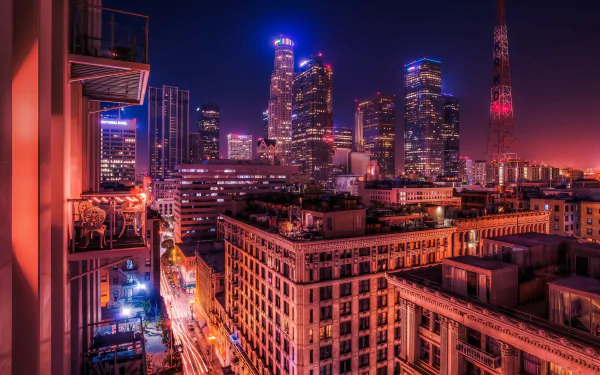 A stunning 4K Ultra HD wallpaper showcasing the vibrant skyline of Los Angeles at night, featuring illuminated skyscrapers and a bustling urban atmosphere.
