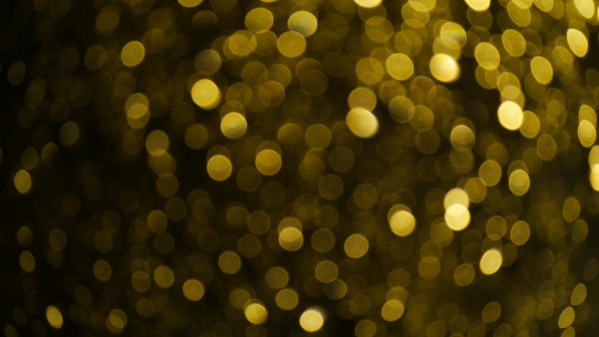 Artistic 4K Ultra HD PC desktop wallpaper featuring golden glitter and warm bokeh lights creating a shimmering, abstract background.
