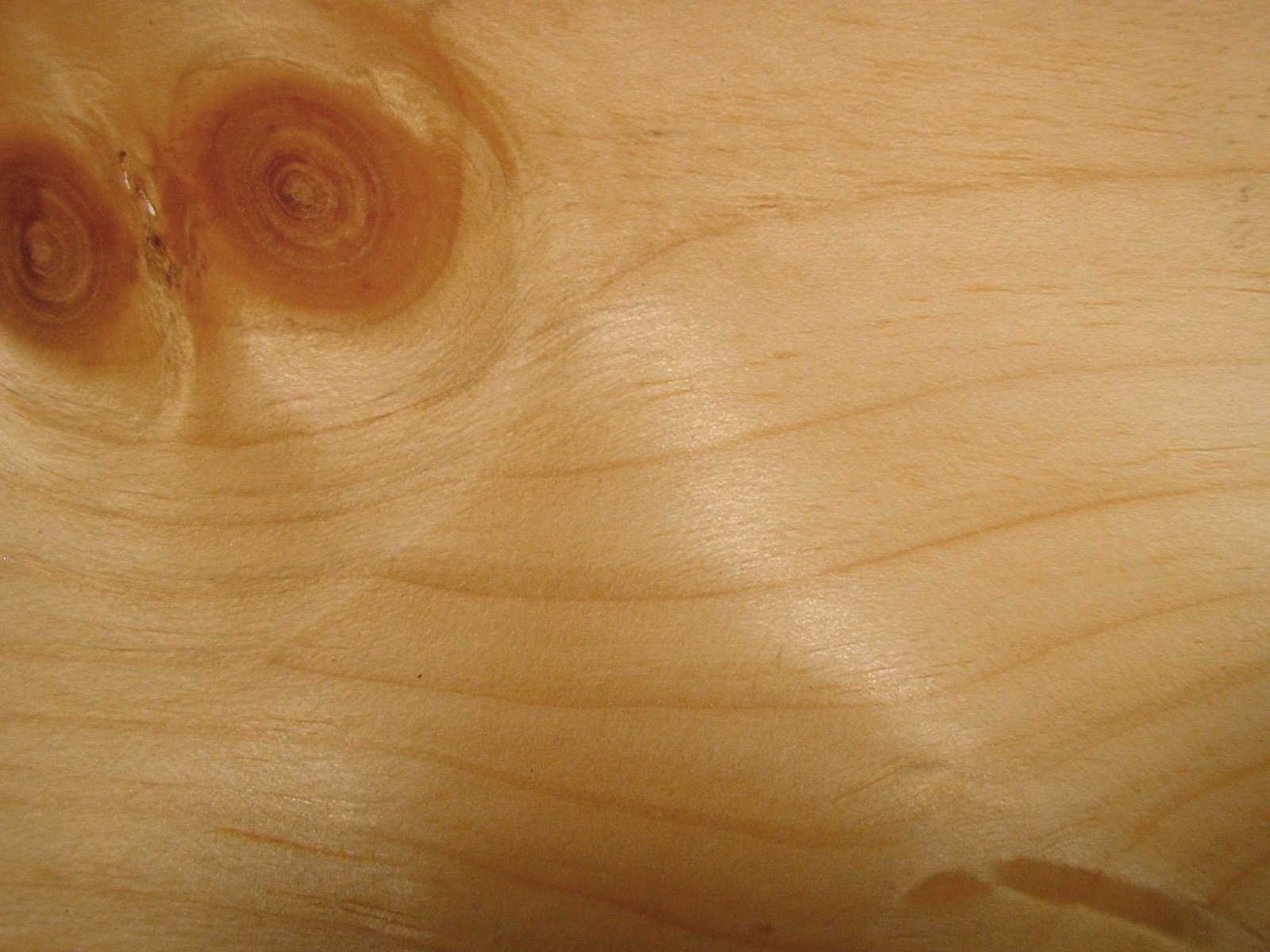 A close-up view of smooth wooden texture, featuring natural grain patterns and warm tones, creating an artistic backdrop for an HD PC desktop wallpaper.