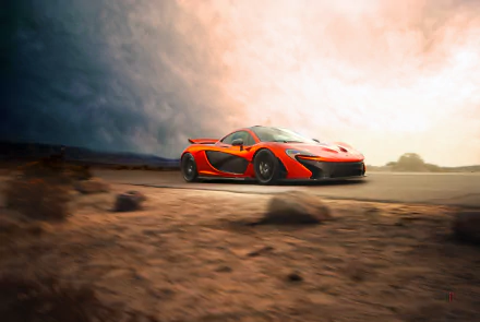 A vivid 4K Ultra HD wallpaper featuring an orange McLaren P1 supercar speeding on a desert road under a dramatic sky.