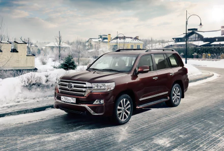 A sleek Toyota Land Cruiser SUV parked on a snowy road, showcasing its elegant design against a winter landscape. Perfect for a 4K Ultra HD desktop wallpaper.