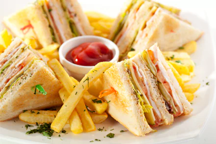 4K Ultra HD wallpaper featuring a plate of stacked sandwiches and golden French fries with a small bowl of ketchup in the center.