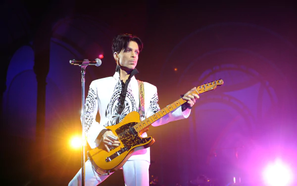 Prince, the iconic musician and singer, performs on stage with a guitar in this vibrant 4K Ultra HD PC desktop wallpaper and background.