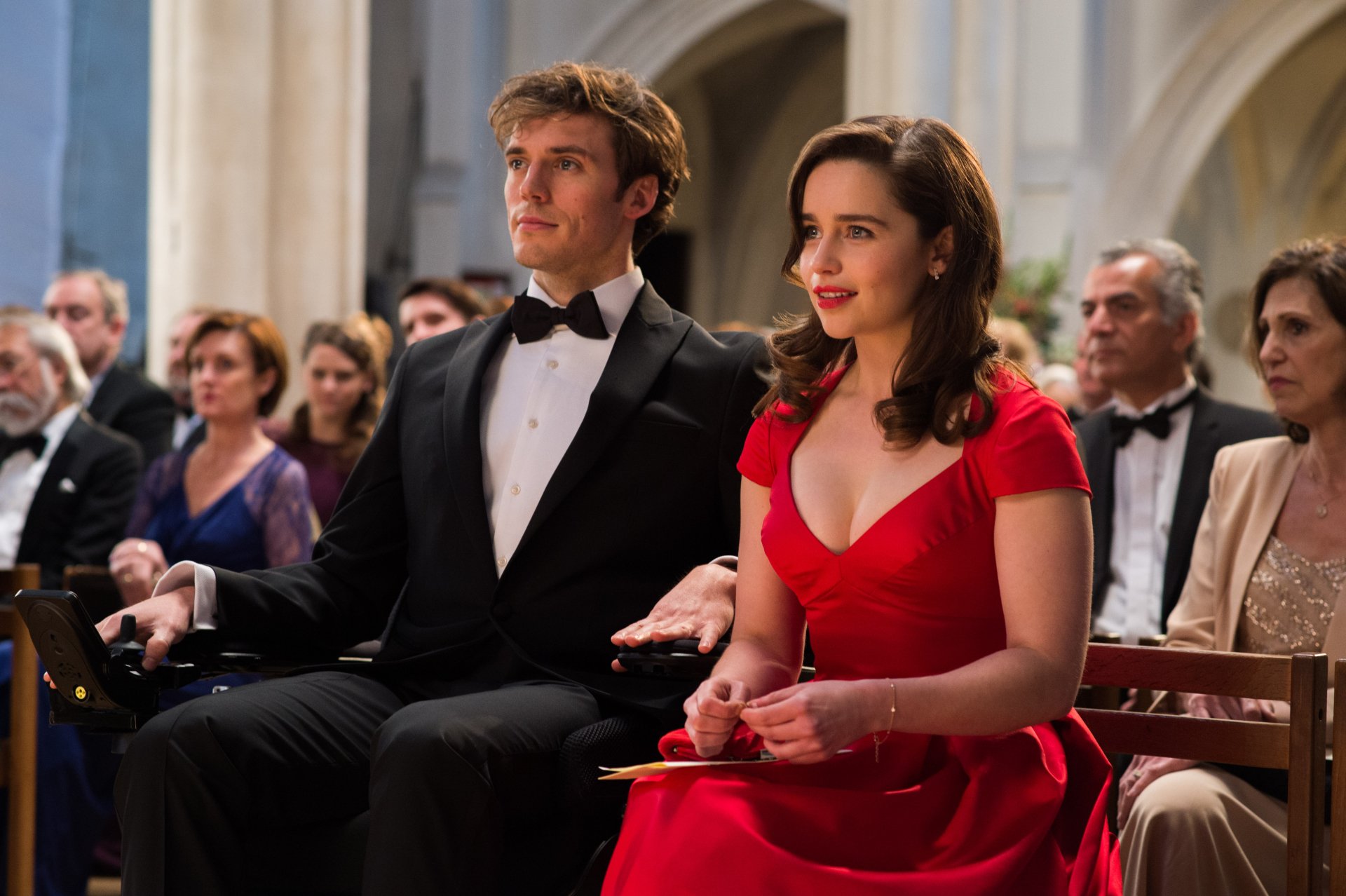 Emilia Clarke and Sam Claflin dressed formally in a scene from the movie Me Before You, featured as a 4K Ultra HD PC desktop wallpaper and background.