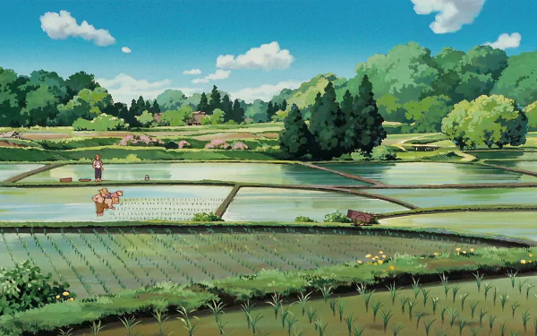 A vibrant HD wallpaper featuring a scenic rural landscape from the anime My Neighbor Totoro, showcasing rice fields and lush greenery under a clear blue sky.