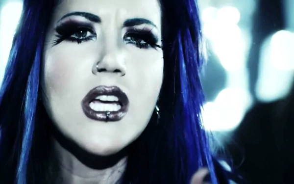 HD PC desktop wallpaper featuring a close-up of a woman with blue hair and dramatic makeup, linked to the music band Arch Enemy.