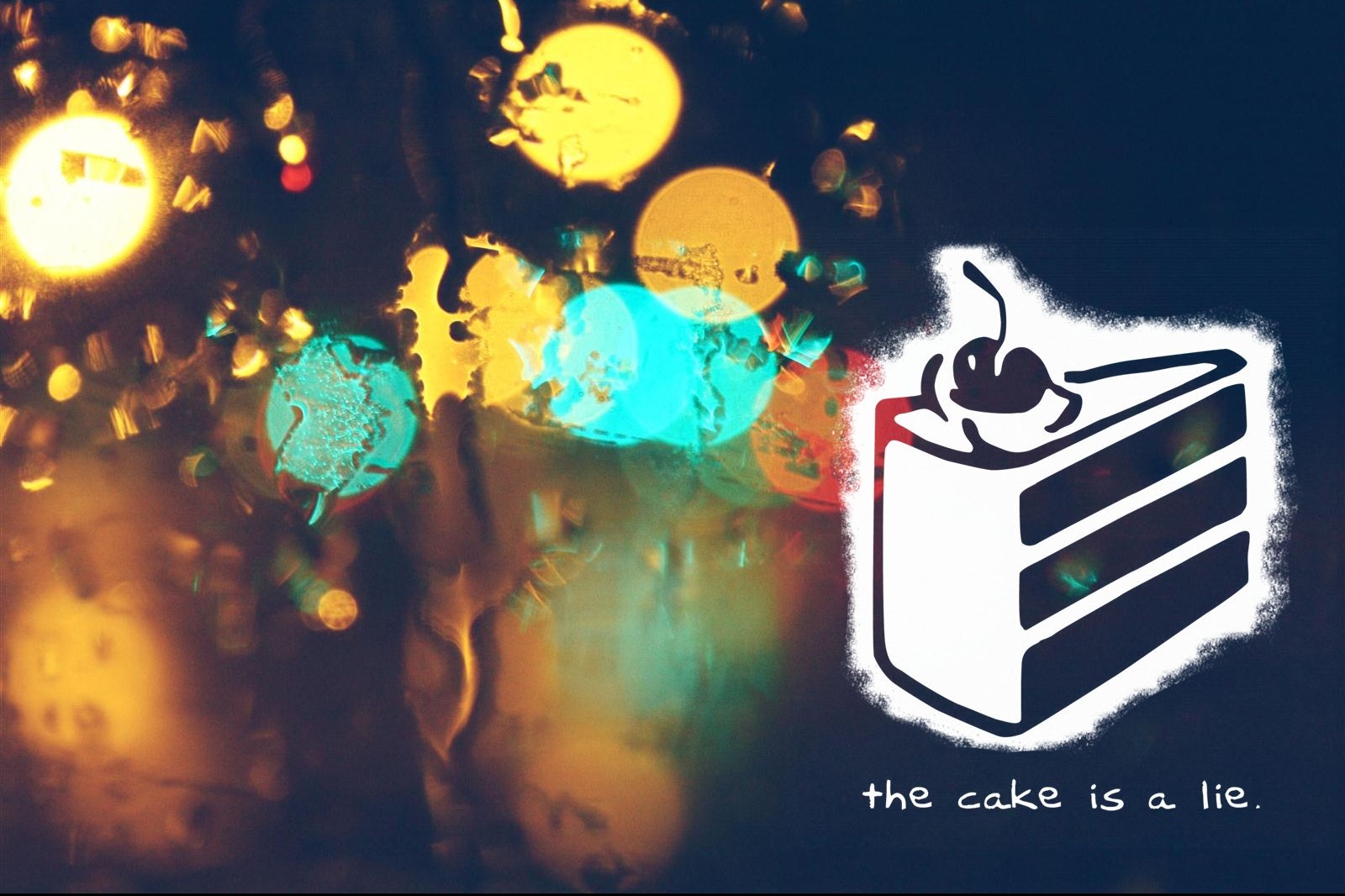 HD PC desktop wallpaper featuring a blurred, colorful background with the iconic the cake is a lie cake slice from the Portal video game.