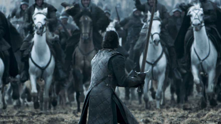 HD wallpaper of Kit Harington as Jon Snow in Game of Thrones, facing a cavalry charge with sword in hand on a battlefield.