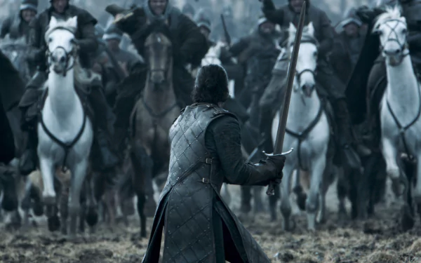 HD wallpaper of Kit Harington as Jon Snow in Game of Thrones, facing a cavalry charge with sword in hand on a battlefield.