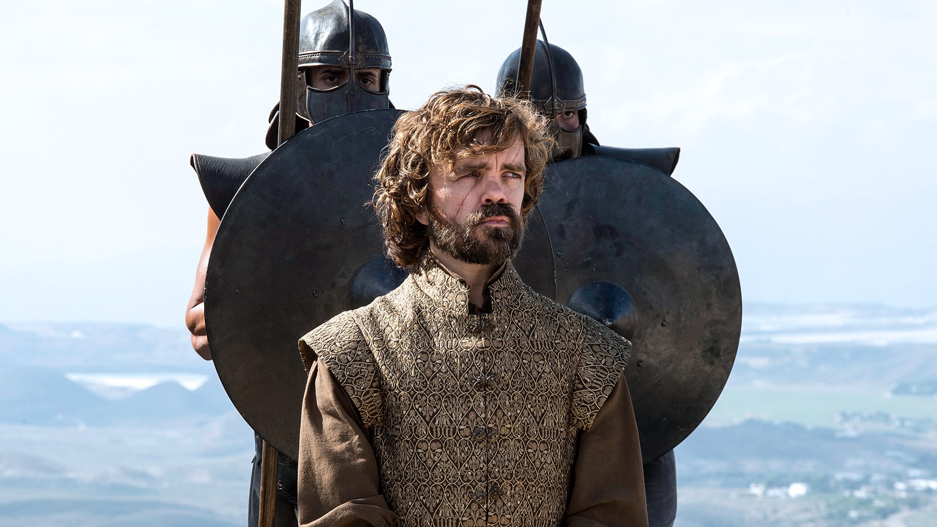 Tyrion Lannister from the TV show Game of Thrones standing before guards on a seaside hill, presented as an HD PC desktop wallpaper and background.