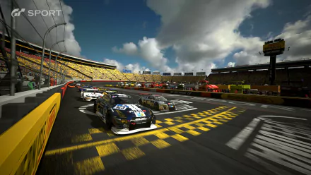 HD PC desktop wallpaper featuring a dynamic Gran Turismo Sport race scene with multiple cars speeding on a sunlit track under a partly cloudy sky.