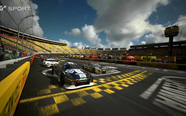 HD PC desktop wallpaper featuring a dynamic Gran Turismo Sport race scene with multiple cars speeding on a sunlit track under a partly cloudy sky.