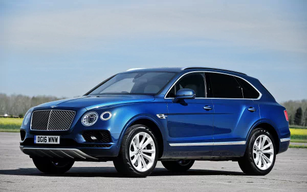 A blue Bentley Bentayga SUV parked on a paved surface under a clear sky, captured in HD for a desktop wallpaper and background.