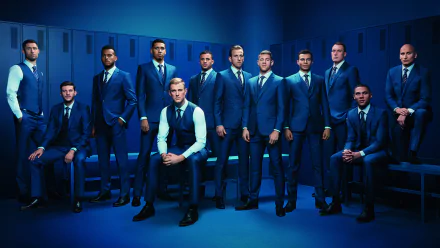 HD PC desktop wallpaper: England UEFA Euro 2016 sports-themed portrait of a football squad in matching blue suits posed in a locker room, formal, stylized atmosphere.
