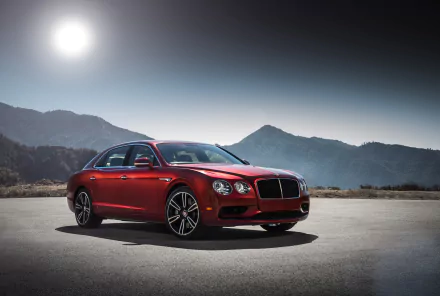A stunning red Bentley Flying Spur parked against a backdrop of mountains, under a bright sun, showcasing its sleek design and luxury features. 4K Ultra HD desktop wallpaper.