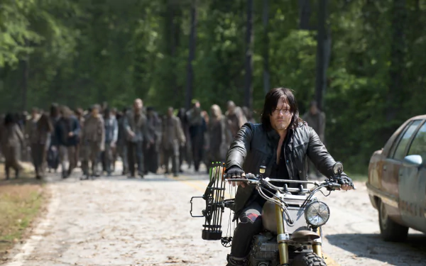 Daryl Dixon, portrayed by Norman Reedus, rides his motorcycle through a zombie-infested landscape from the TV show The Walking Dead in this HD wallpaper.