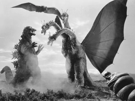 Black-and-white movie HD PC desktop wallpaper: Godzilla clashes with Ghidorah, the Three-Headed Monster, wings unfurled over a smoke-filled landscape.