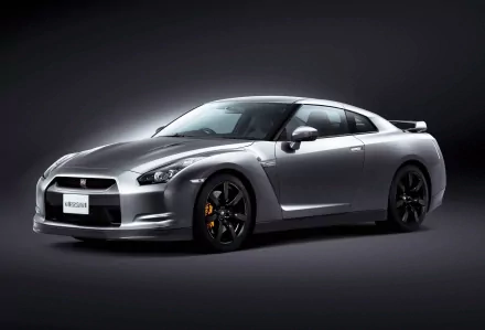 HD wallpaper featuring a sleek silver Nissan GT-R against a dark background.
